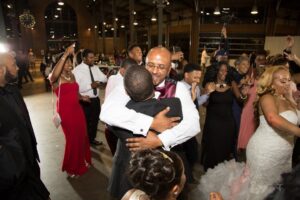 Tyrone Jackson hugging son Corey Jackson at wedding